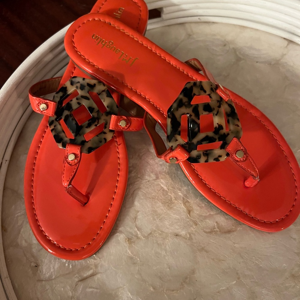 J McLaughlin US size 10 Orange sandals with tortoise emblem.